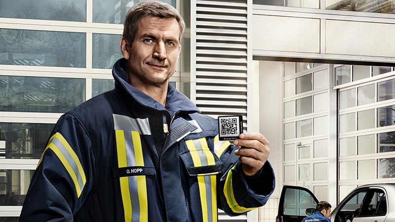 Firefighter with rescue sticker in hand
